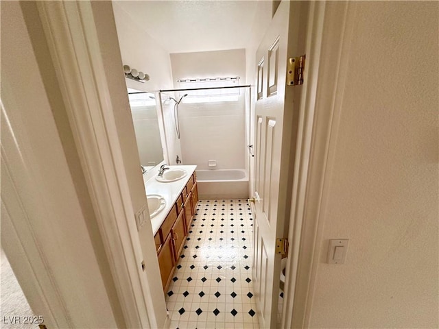 bathroom featuring double vanity, tile patterned floors, and  shower combination