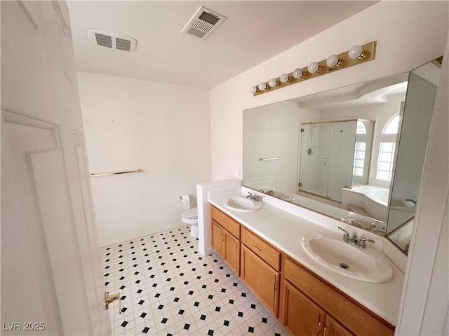 full bathroom with a stall shower, toilet, a bath, double vanity, and tile patterned floors