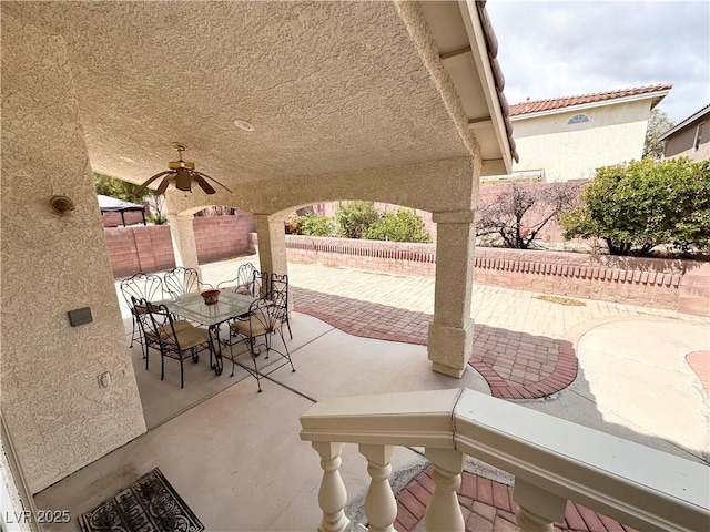 view of patio featuring a fenced backyard, a ceiling fan, and outdoor dining area