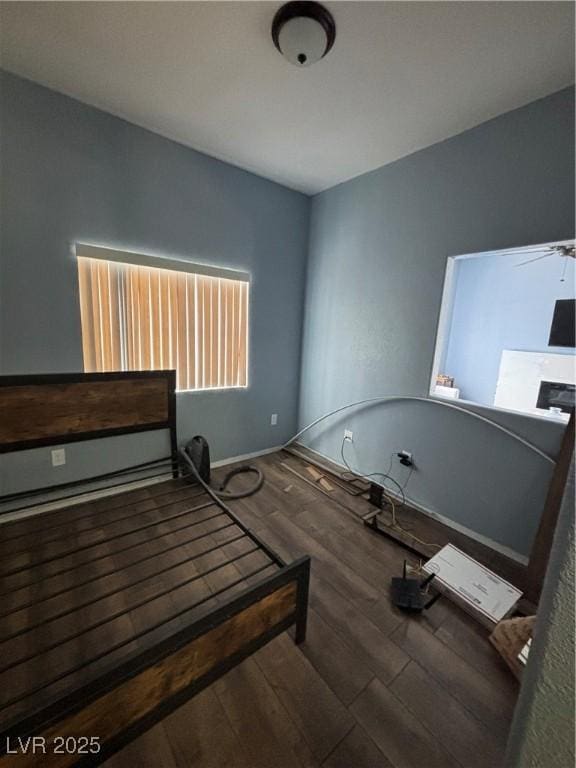unfurnished bedroom with baseboards and wood finished floors