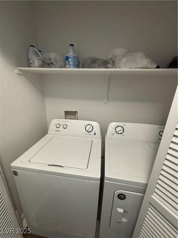 washroom featuring washing machine and clothes dryer and laundry area