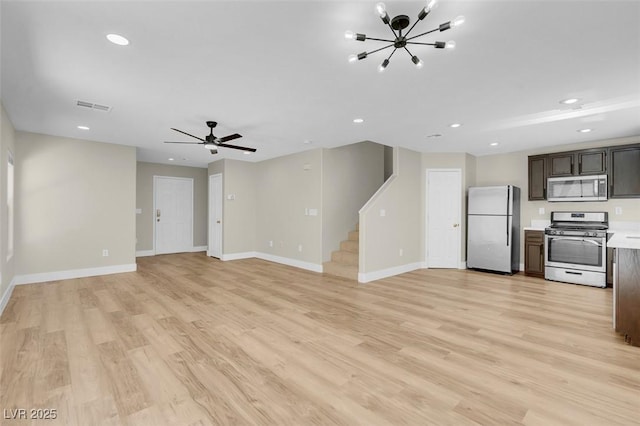 unfurnished living room featuring recessed lighting, visible vents, stairway, and baseboards