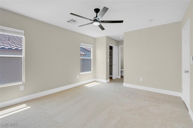 unfurnished bedroom with a ceiling fan, visible vents, carpet, and baseboards