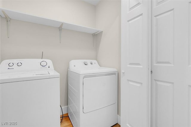 laundry room featuring light wood finished floors, independent washer and dryer, and laundry area