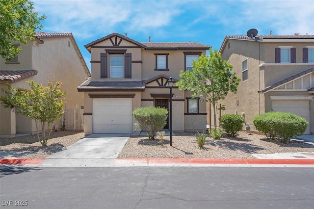 view of front of home with a garage, fence, stucco siding, and concrete driveway