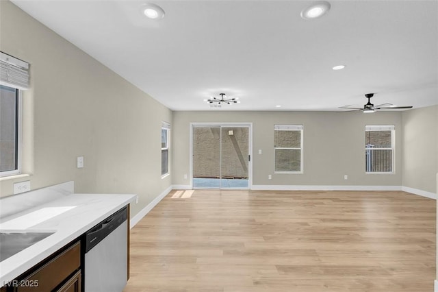 unfurnished living room with baseboards, light wood-type flooring, a ceiling fan, and recessed lighting