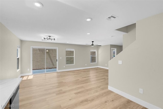 unfurnished living room with visible vents, a ceiling fan, recessed lighting, and baseboards