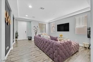 living area featuring baseboards, recessed lighting, and wood finished floors
