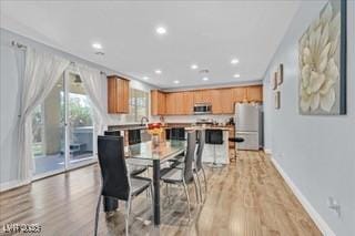dining area featuring baseboards, recessed lighting, and light wood-style flooring