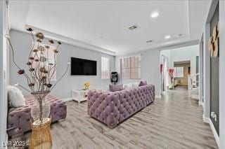living room with baseboards, recessed lighting, wood finished floors, and visible vents