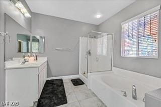 bathroom featuring a garden tub, vanity, and a shower stall