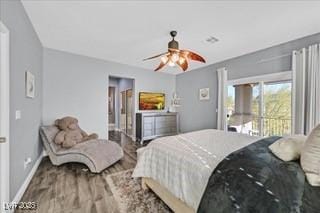 bedroom with baseboards, ceiling fan, wood finished floors, and access to exterior