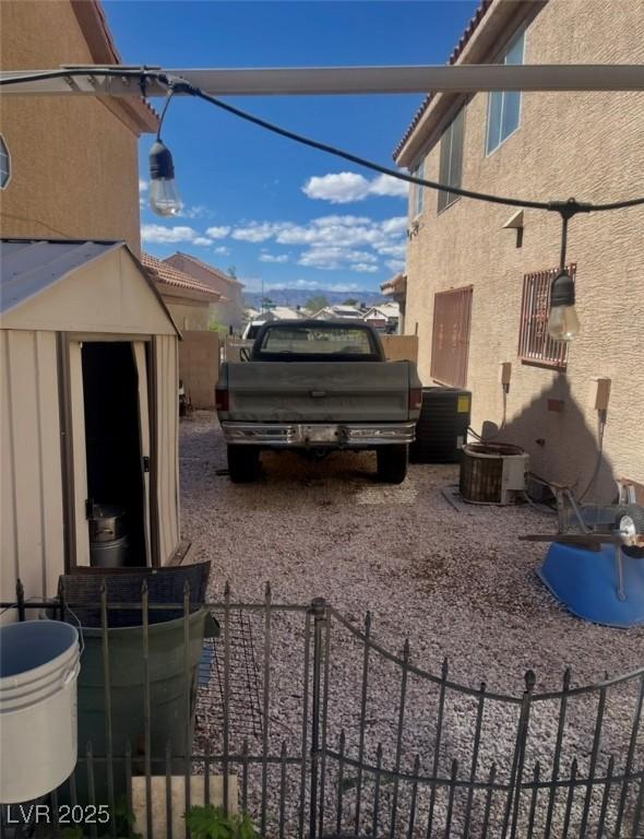 6429 Rosemount Ave, Las Vegas, NV 89156 - view of side of home with stucco siding, central AC unit, and a tile roof