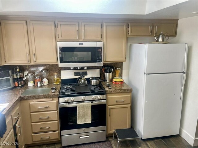 6429 Rosemount Ave, Las Vegas, NV 89156 - kitchen with appliances with stainless steel finishes, tasteful backsplash, and dark wood-style floors