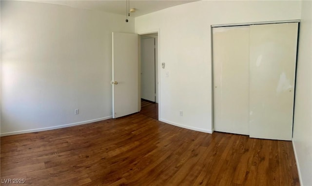 6429 Rosemount Ave, Las Vegas, NV 89156 - unfurnished bedroom with wood finished floors, a closet, and baseboards