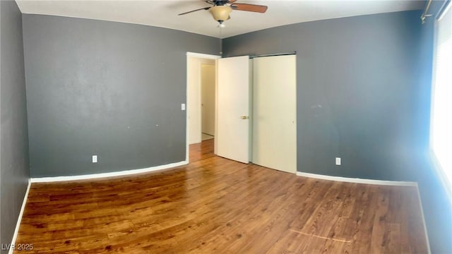 6429 Rosemount Ave, Las Vegas, NV 89156 - unfurnished bedroom featuring wood finished floors, baseboards, a closet, and ceiling fan