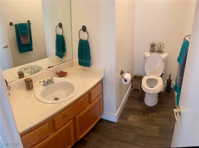 6429 Rosemount Ave, Las Vegas, NV 89156 - half bath with vanity, wood finished floors, toilet, and baseboards
