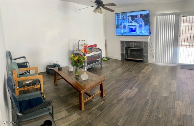 6429 Rosemount Ave, Las Vegas, NV 89156 - living room featuring ceiling fan, dark wood-style flooring, a fireplace, and baseboards