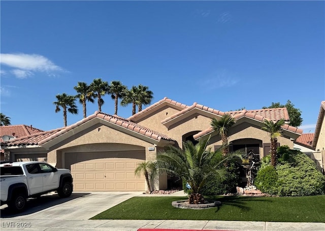 mediterranean / spanish-style home featuring a garage, a front lawn, driveway, and stucco siding