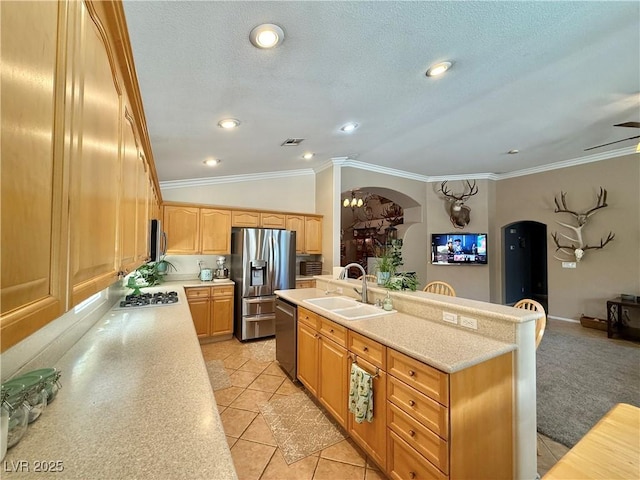 2986 Matese Dr, Henderson, NV 89052 - kitchen featuring light countertops, arched walkways, a sink, and stainless steel appliances