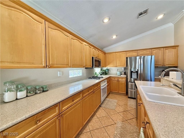 2986 Matese Dr, Henderson, NV 89052 - kitchen with crown molding, appliances with stainless steel finishes, a sink, visible vents, and vaulted ceiling