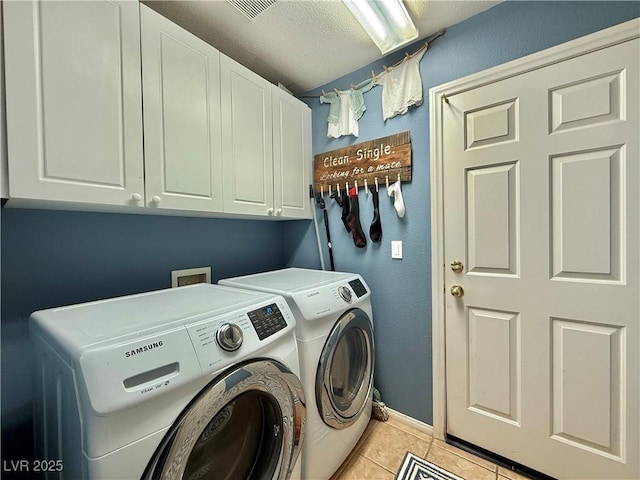 2986 Matese Dr, Henderson, NV 89052 - clothes washing area with baseboards, washer and clothes dryer, a textured ceiling, cabinet space, and light tile patterned floors