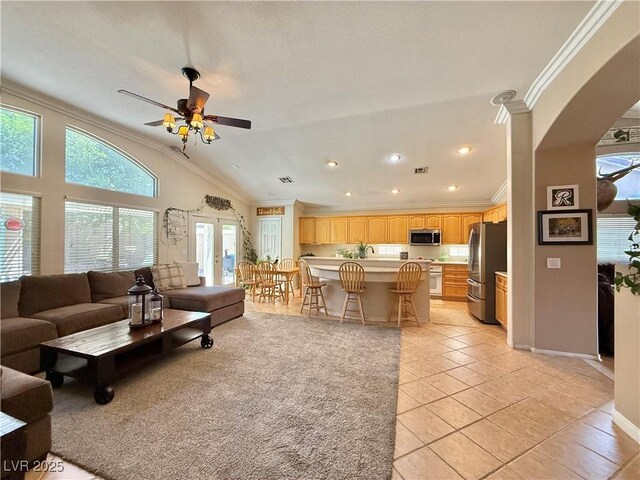 2986 Matese Dr, Henderson, NV 89052 - living area with crown molding, light tile patterned floors, a ceiling fan, and lofted ceiling