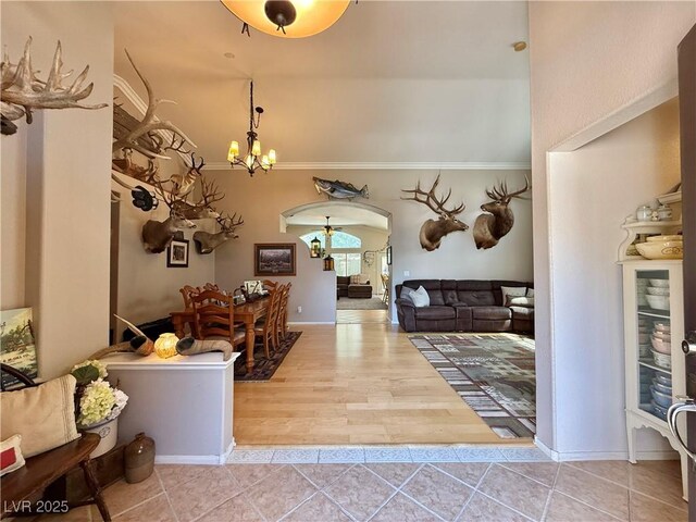 2986 Matese Dr, Henderson, NV 89052 - foyer entrance with tile patterned flooring, arched walkways, and a notable chandelier