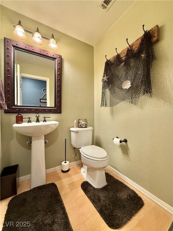 2986 Matese Dr, Henderson, NV 89052 - bathroom featuring baseboards, toilet, and visible vents