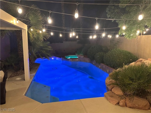 2986 Matese Dr, Henderson, NV 89052 - pool at night with a fenced backyard and an outdoor pool