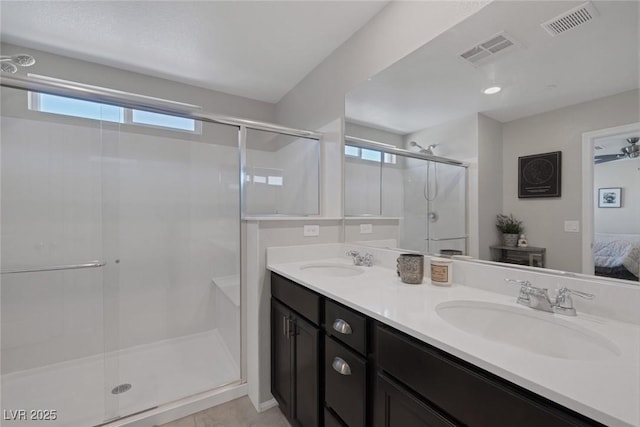 ensuite bathroom with visible vents, a shower stall, ensuite bathroom, and a sink