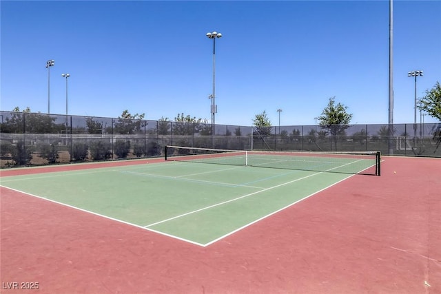 view of tennis court featuring fence and community basketball court