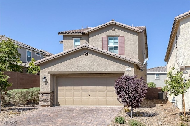 view of front of house with fence, stucco siding, and a tiled roof