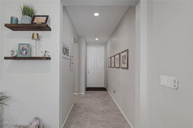 hall with baseboards and recessed lighting