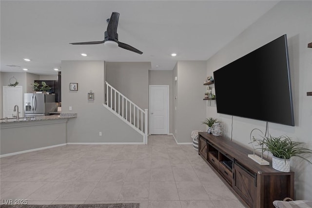living area with baseboards, light tile patterned flooring, recessed lighting, a ceiling fan, and stairs