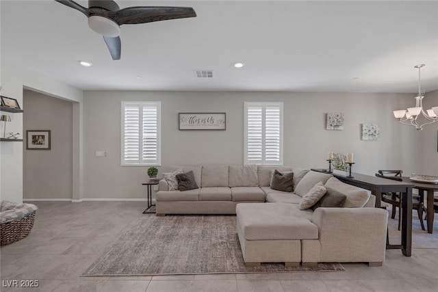 living room with recessed lighting, light tile patterned floors, visible vents, baseboards, and ceiling fan with notable chandelier