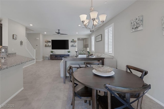 dining space featuring light tile patterned floors, baseboards, recessed lighting, ceiling fan with notable chandelier, and stairs
