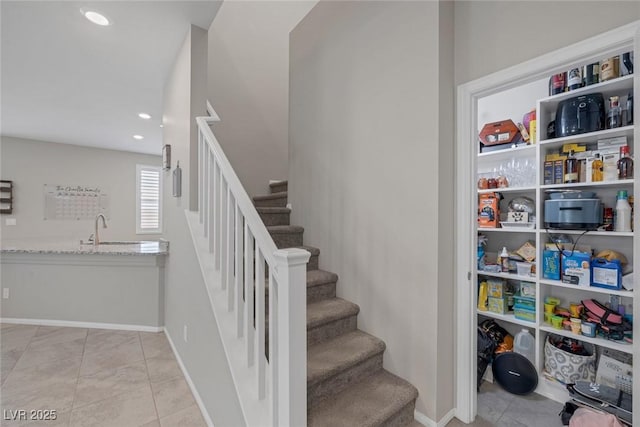 stairway featuring recessed lighting, tile patterned floors, and baseboards