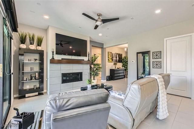 living area featuring recessed lighting, ceiling fan, light tile patterned floors, and a fireplace