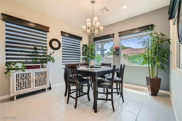 dining space with an inviting chandelier, baseboards, and visible vents