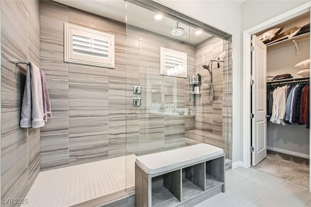 bathroom with a walk in shower, recessed lighting, and a walk in closet