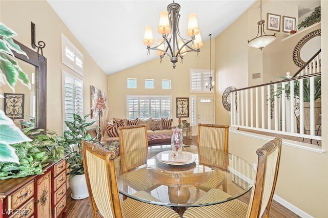 3295 Cooper Creek Dr, Henderson, NV 89074 - dining area with high vaulted ceiling, wood finished floors, a chandelier, and a healthy amount of sunlight