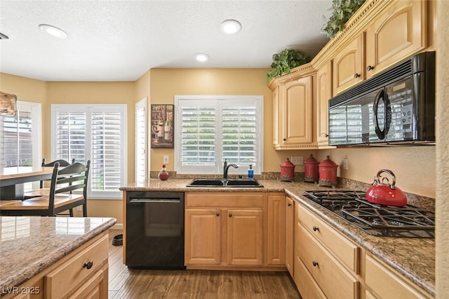 3295 Cooper Creek Dr, Henderson, NV 89074 - kitchen with recessed lighting, a sink, light brown cabinets, black appliances, and light wood-style flooring