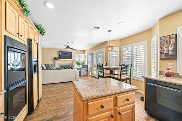 3295 Cooper Creek Dr, Henderson, NV 89074 - kitchen with a textured ceiling, dishwashing machine, light brown cabinets, and dobule oven black