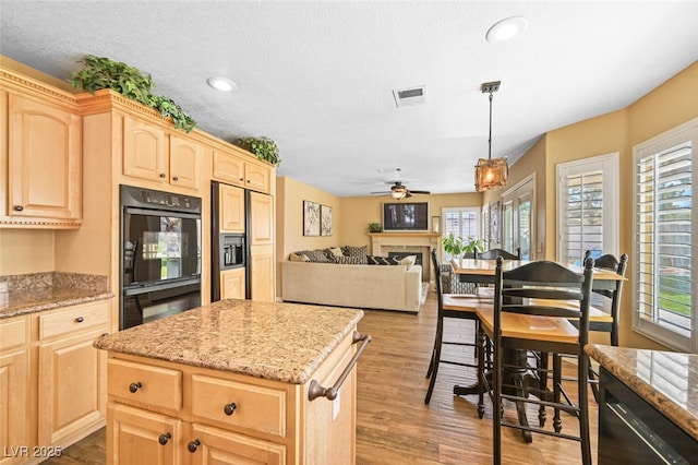 3295 Cooper Creek Dr, Henderson, NV 89074 - kitchen featuring light brown cabinetry, visible vents, black appliances, and ceiling fan