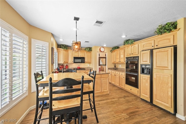 3295 Cooper Creek Dr, Henderson, NV 89074 - kitchen with black appliances, light wood-type flooring, light countertops, and light brown cabinetry