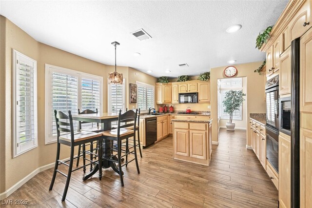 3295 Cooper Creek Dr, Henderson, NV 89074 - kitchen with light brown cabinetry, visible vents, black appliances, and baseboards