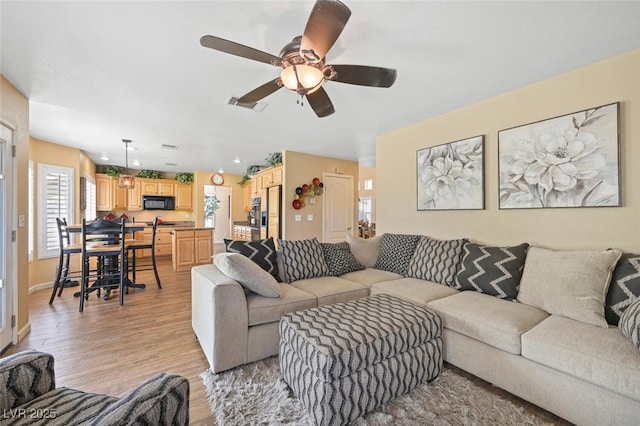 3295 Cooper Creek Dr, Henderson, NV 89074 - living area featuring ceiling fan, visible vents, light wood-type flooring, and baseboards