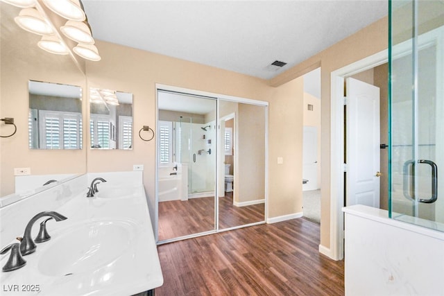 3295 Cooper Creek Dr, Henderson, NV 89074 - full bath featuring toilet, a sink, wood finished floors, and visible vents
