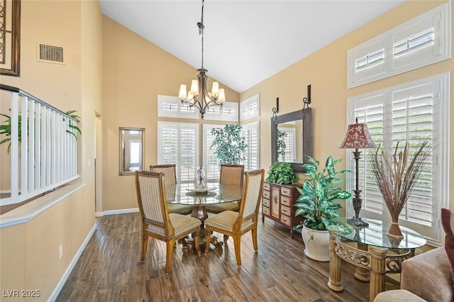 3295 Cooper Creek Dr, Henderson, NV 89074 - dining area with an inviting chandelier, a healthy amount of sunlight, dark wood-style floors, visible vents, and high vaulted ceiling